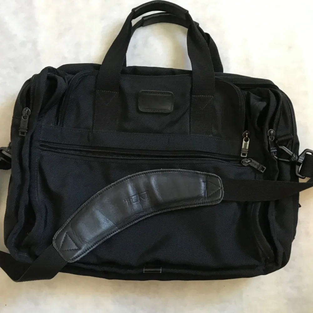 Tumi Black expandable laptop bag. clean interior. Work, travel, Classic